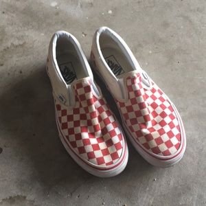Red and white Checkerboard Vans Sneakers.